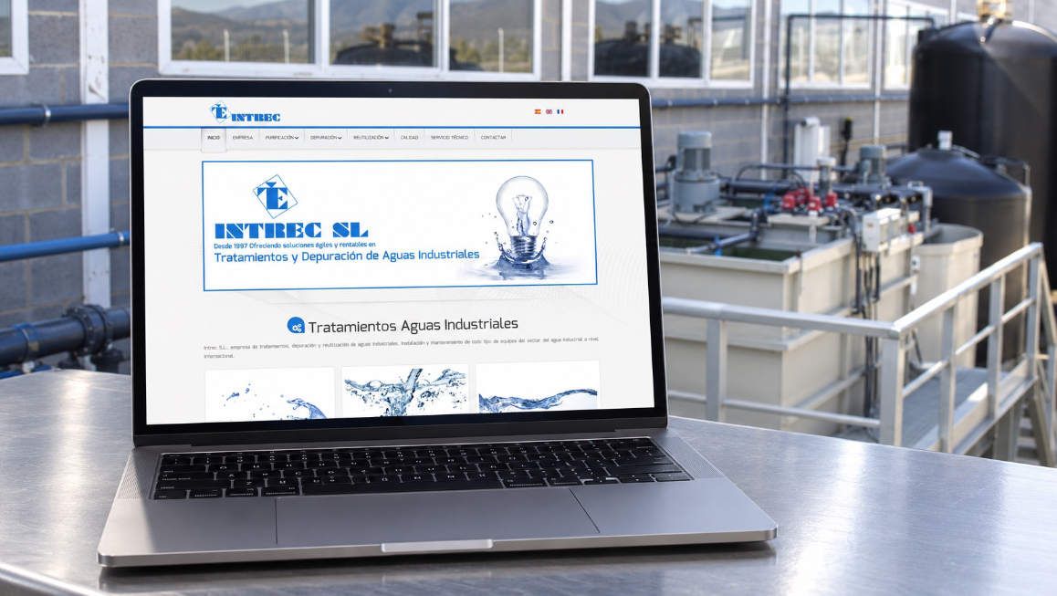 INTREC, diseño web para tratamiento de aguas industriales Mockup de la web de INTREC en un portátil, con una instalación de tratamiento de aguas industriales al fondo